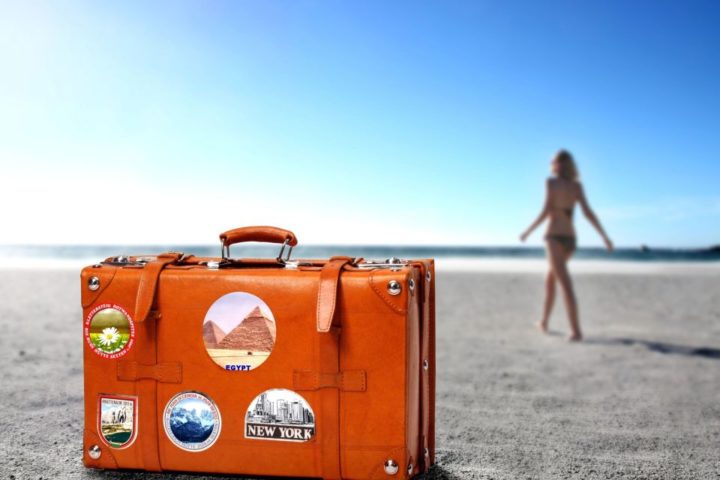 orange-color-suitcase-travel-beach-sand-horizon-girl-resort-1024x640